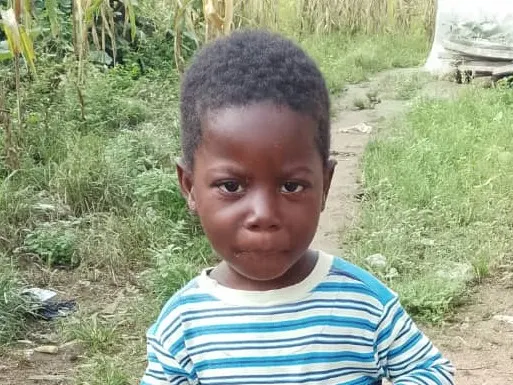 A young child in a striped top